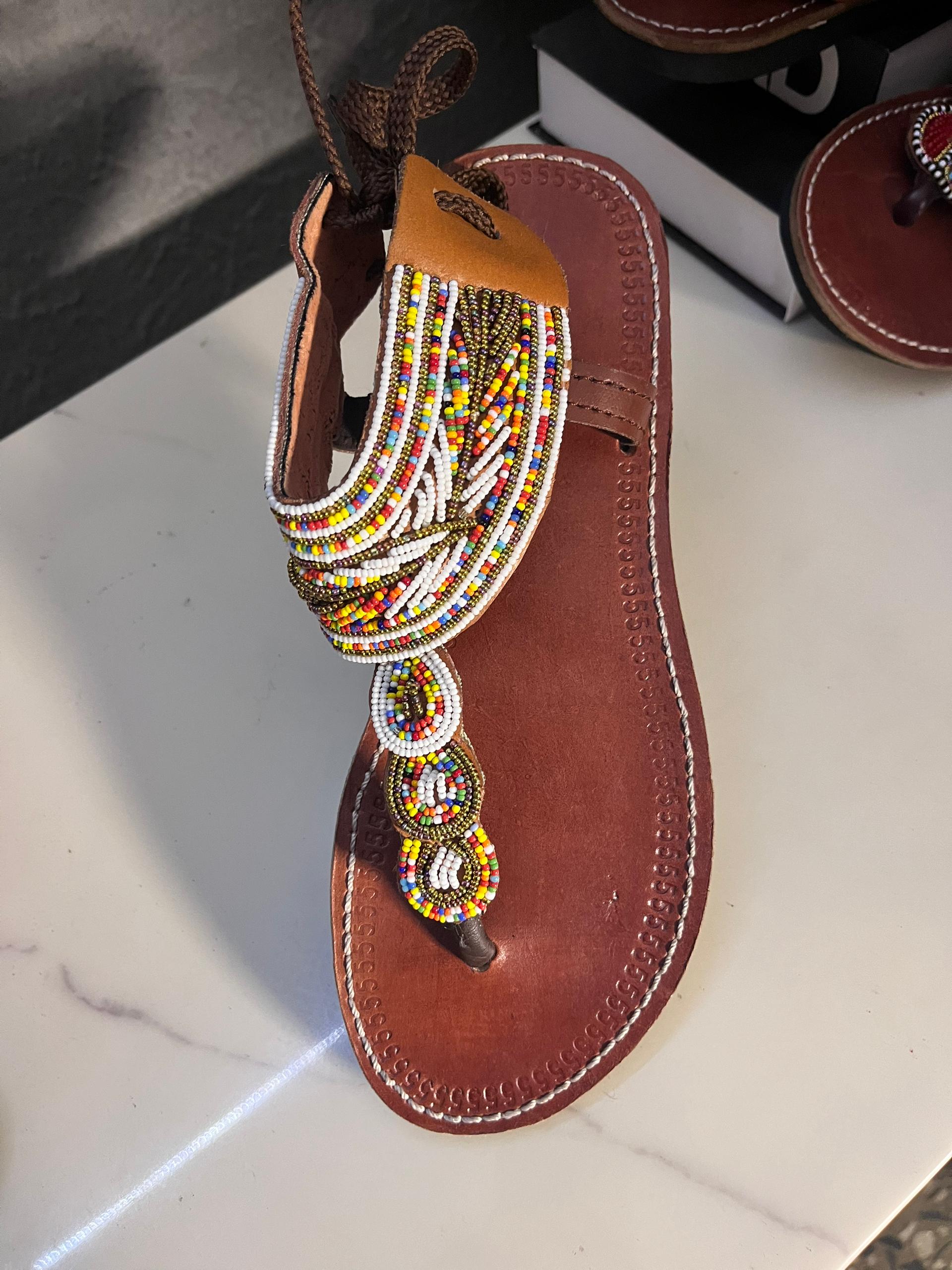 Close-up zoomed view of Maasai Sandals Multicolored — intricate rainbow beadwork on leather